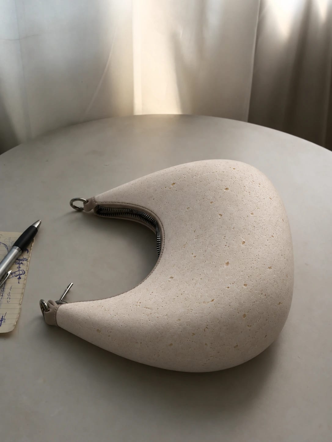 An earlier working version of PORTALE, zip closure and texture trial, beside the sketch