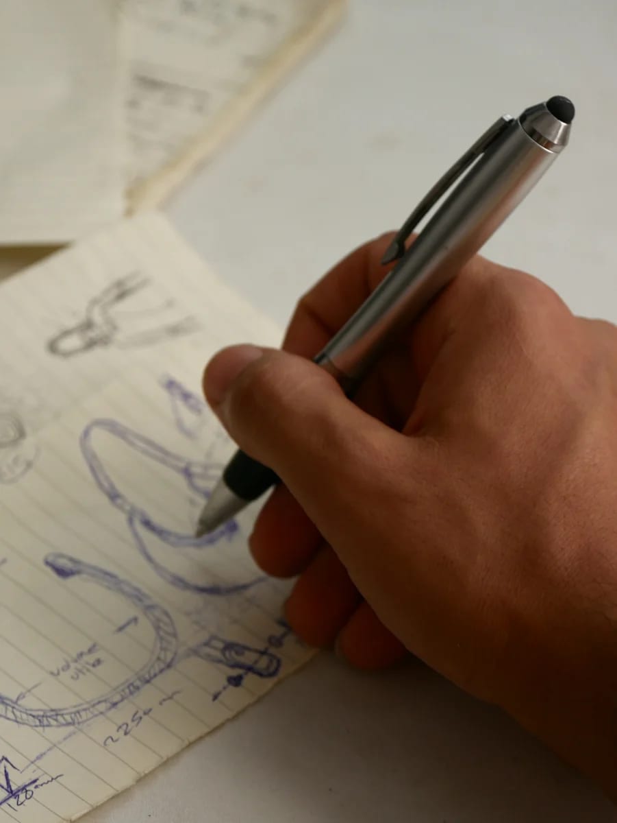 Emir’s hand drawing PORTALE in pen on a sketchbook page