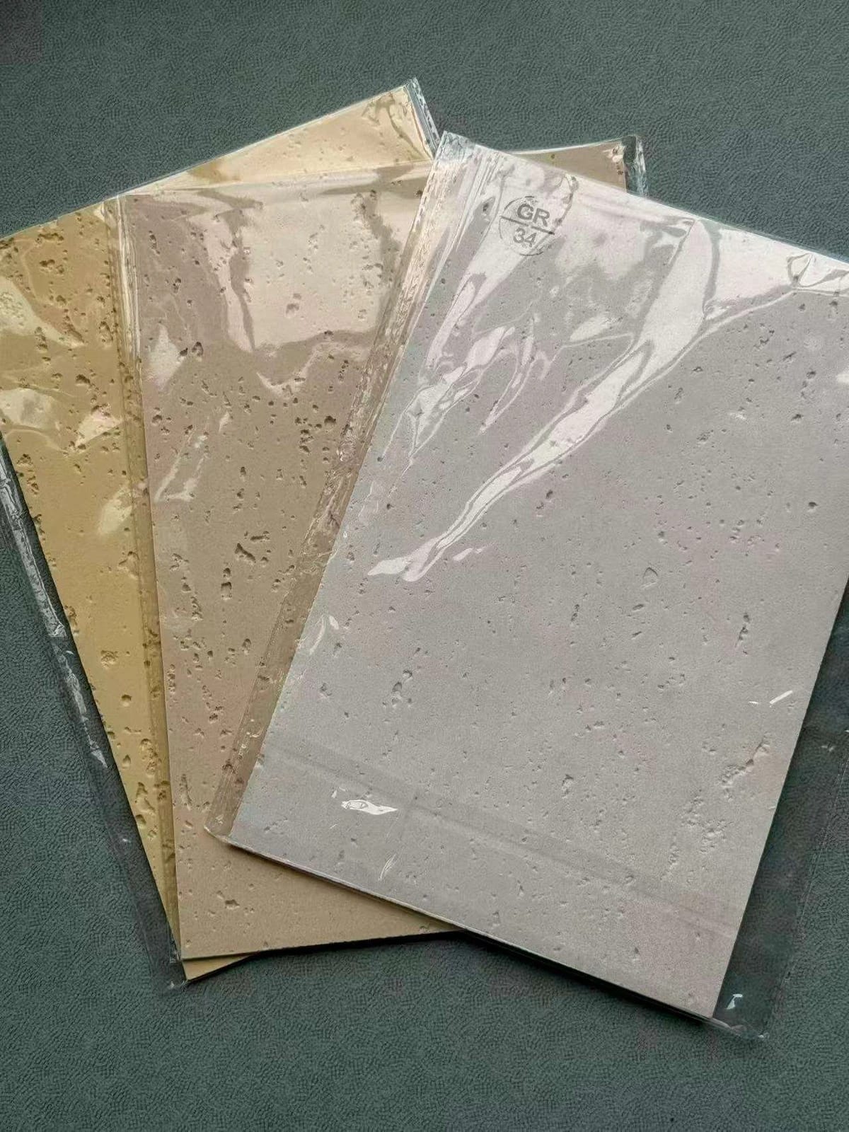 Ivory, sand and grey mineral samples compared under their protective wrapping