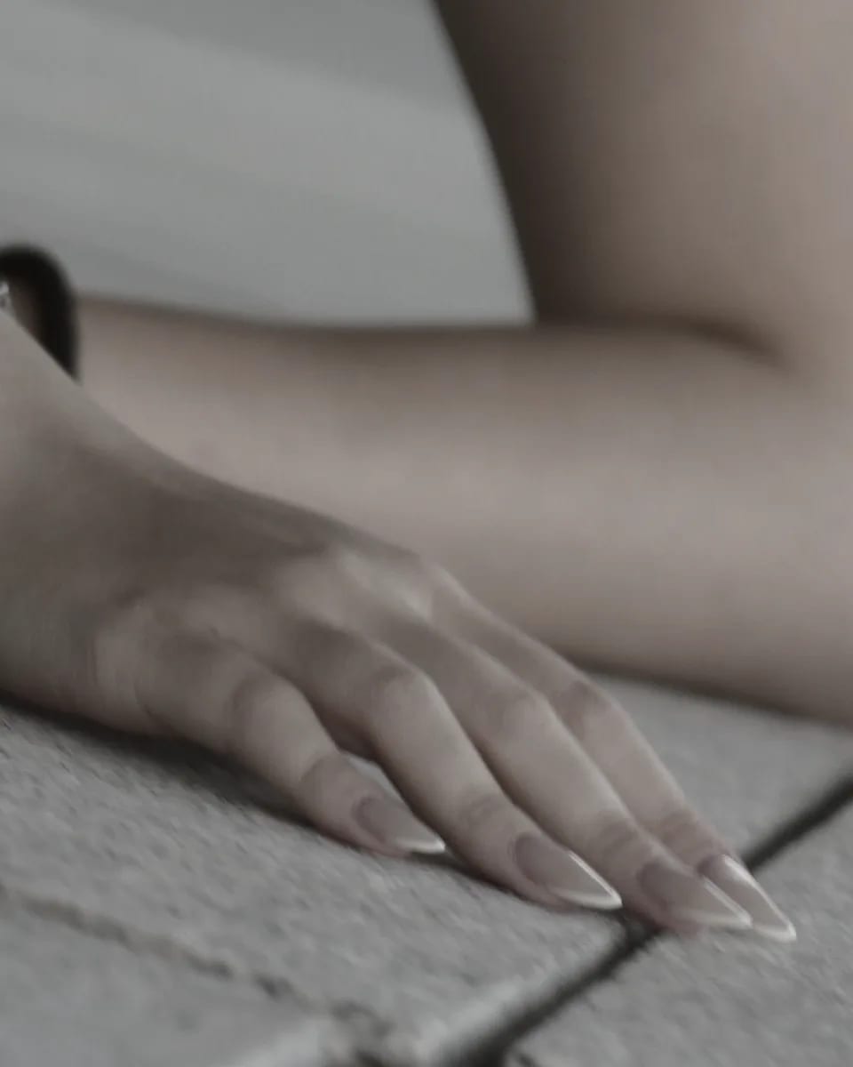 A hand resting on stone